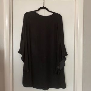 Black knee length dress with dramatic sleeves